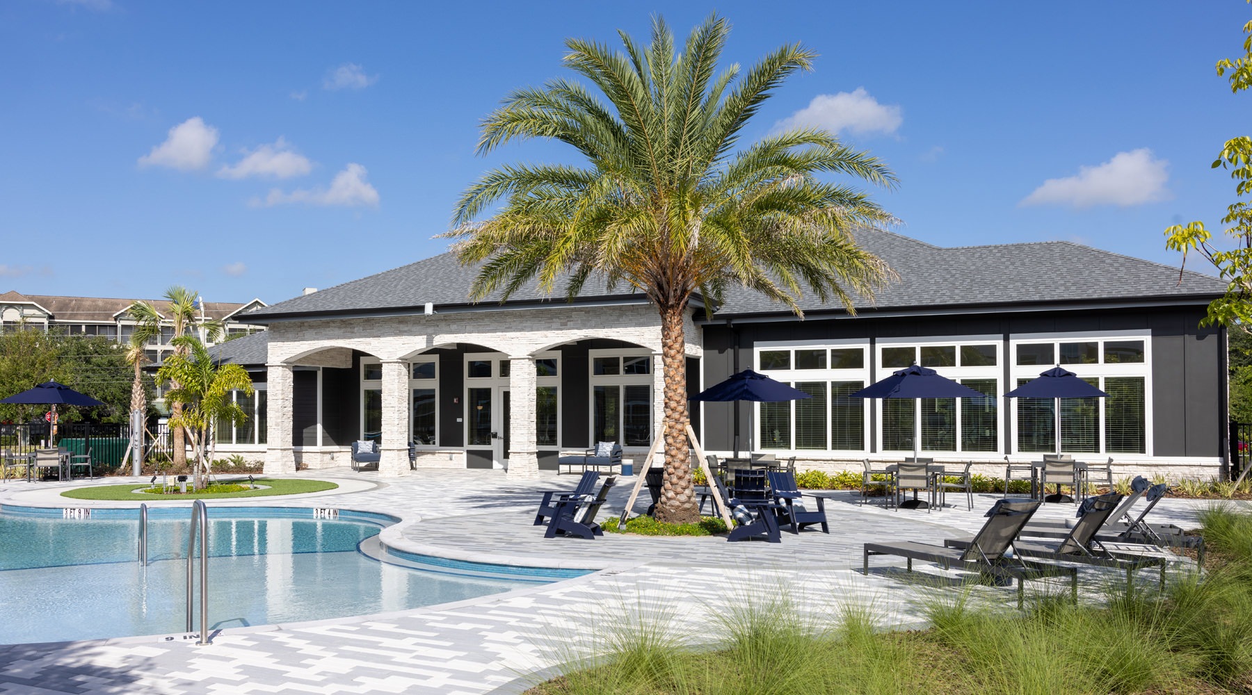 Resort-style swimming pool with lounge seating